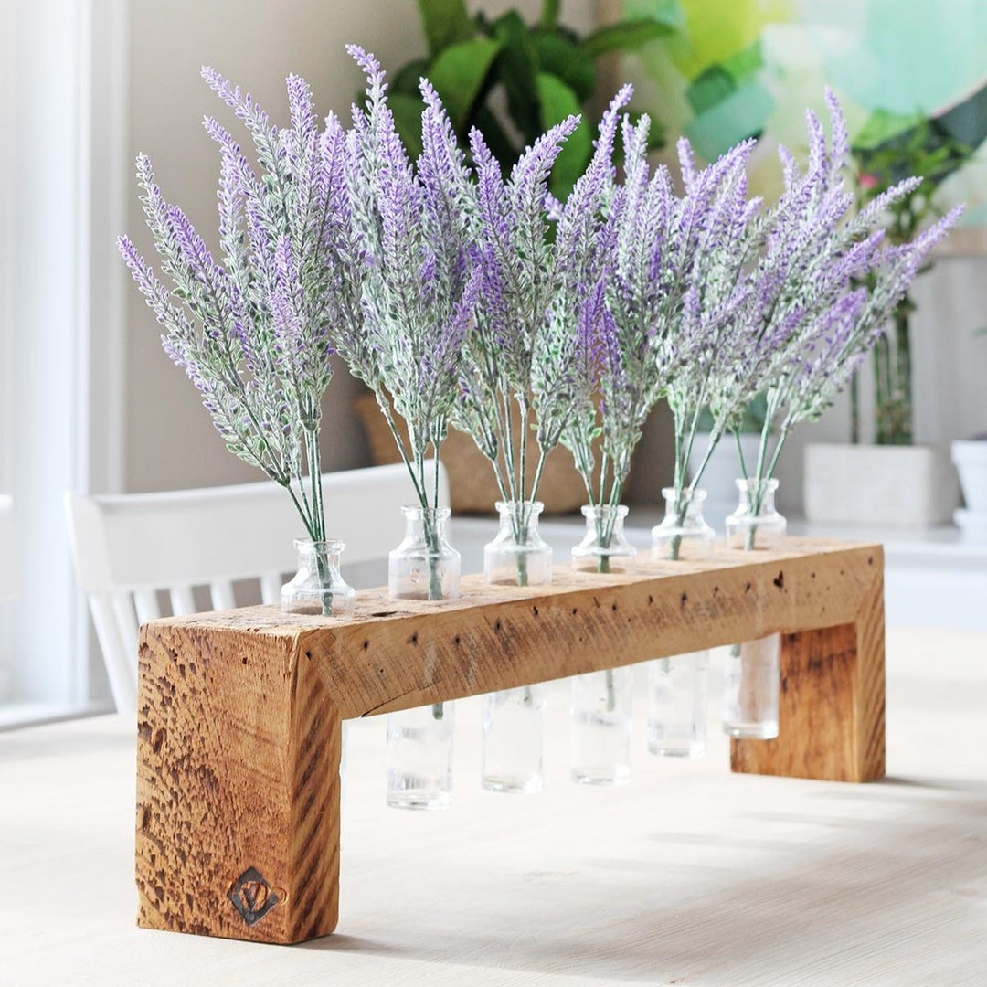 reclaimed wood centerpiece with glass bud vaseson dining table