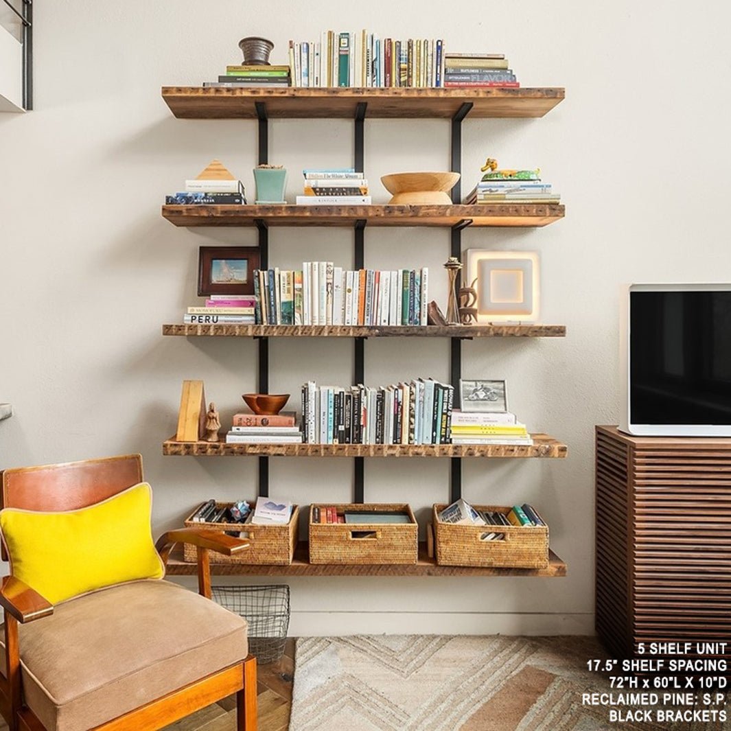 Wall mount shelving unit in boho living room. Heavy duty custom Bookshelf with floating metal wall brackets and 5 reclaimed wood shelves. Wall mount shelf brackets from solid steel channel with reclaimed pine shelves. Floating shelves Handmade in USA by Vault Furniture