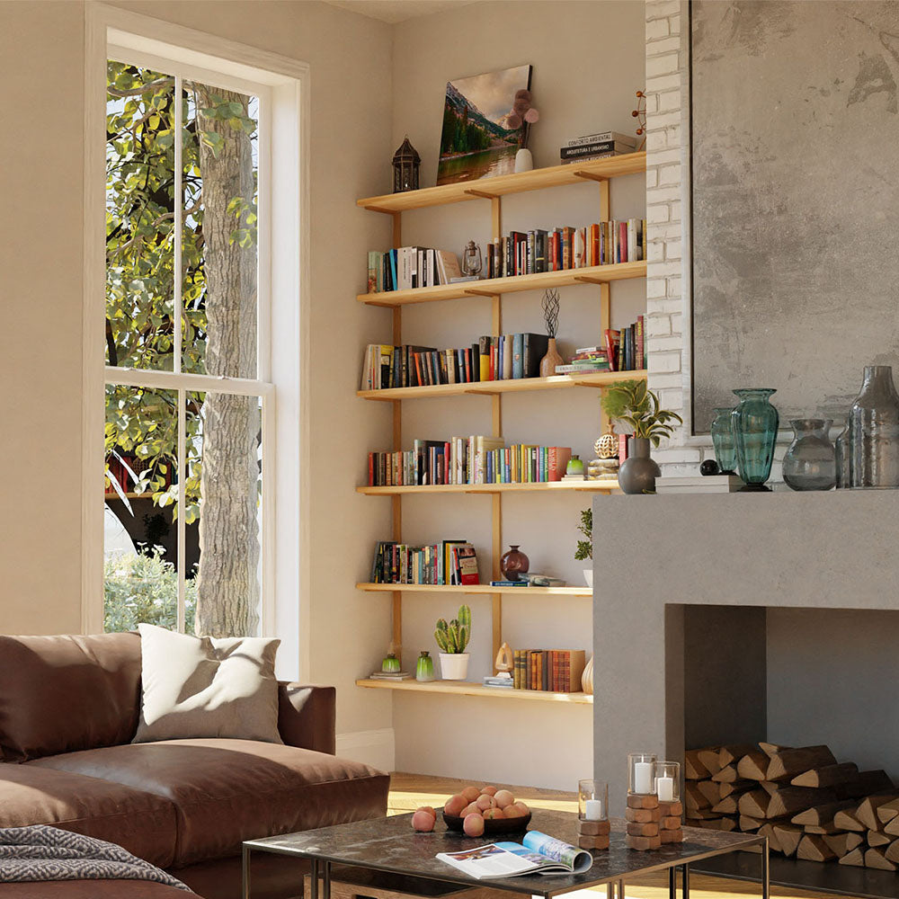 large living room bookshelves. tall ceiling with floor to ceiling bookshelves custom fit to nook next to fireplace. Light wood with brass shelf brackets next to windows. leather sectional and square coffee table. shelving by vault furnitur