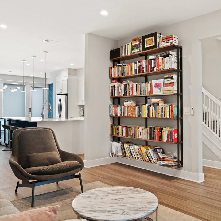 large heavy-duty wall-mounted solid wood and steel shelving unit with bookend brackets for book collection or display decor in a modern living room