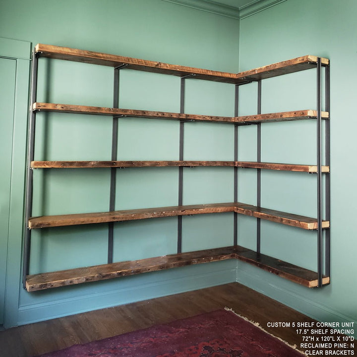 wall mounted corner bookshelf handmade in USA with heavy duty solid steel shelf brackets and 1.5" reclaimed pine wood shelves. Floating bookcase on green wall with solid metal shelf brackets. 5 tier shelving unit by Vault Furniture