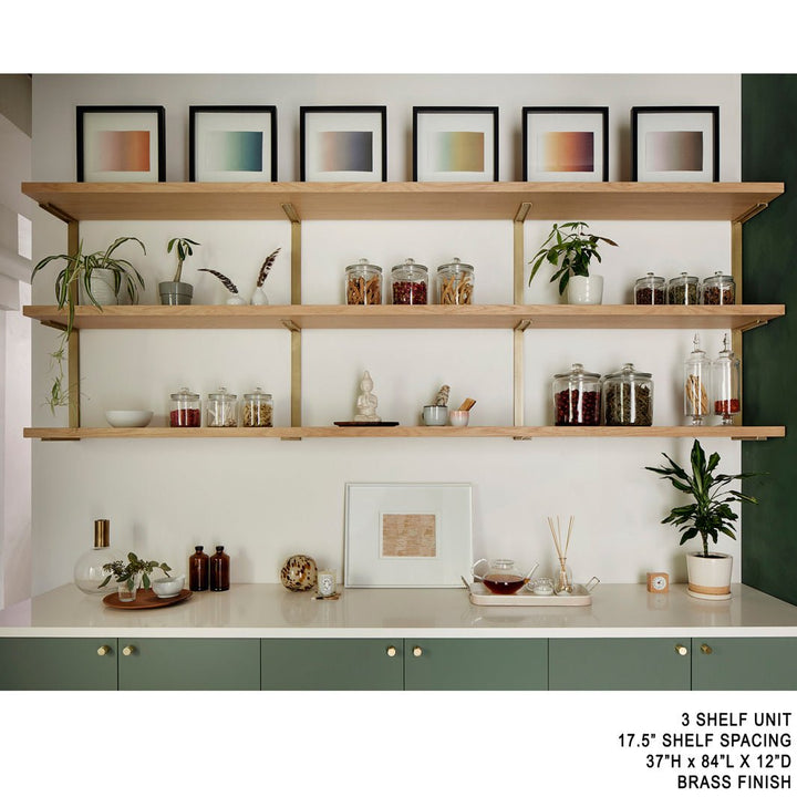 Heavy duty solid steel shelf brackets with brass powder coat finish. Three floating shelves above sage cabinetry and green wall. Apothecary storage shelves by Vault Furniture