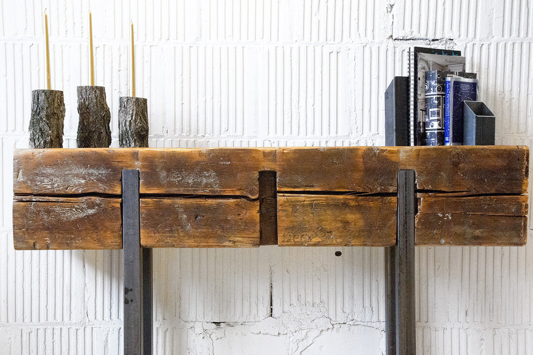 solid wood beam console table with steel legs in front of white wall