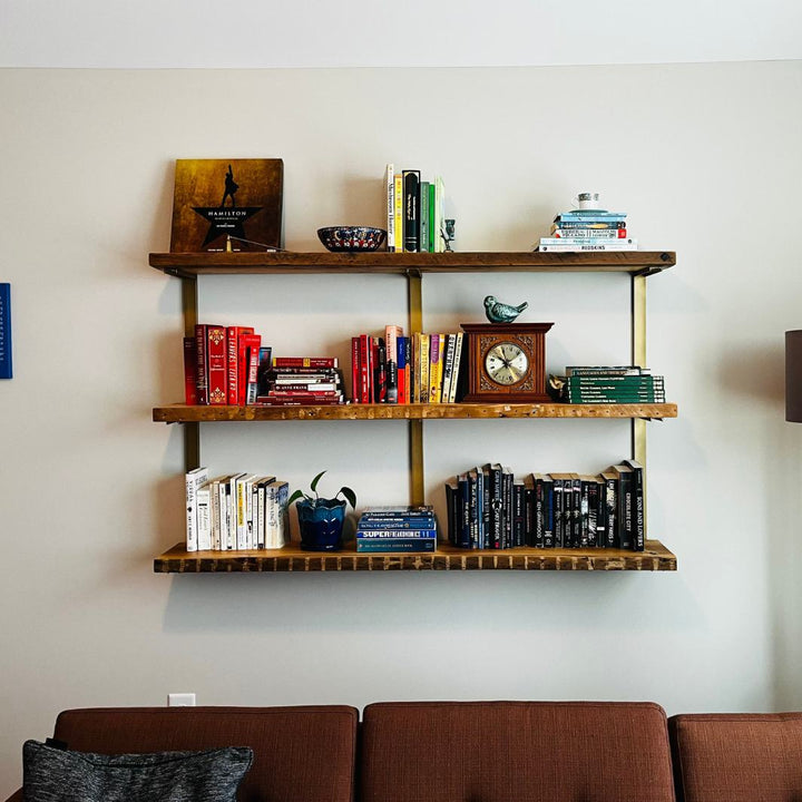 solid reclaimed pine wood floating shelves and brass steel brackets. heavy duty floating bookshelf unit.