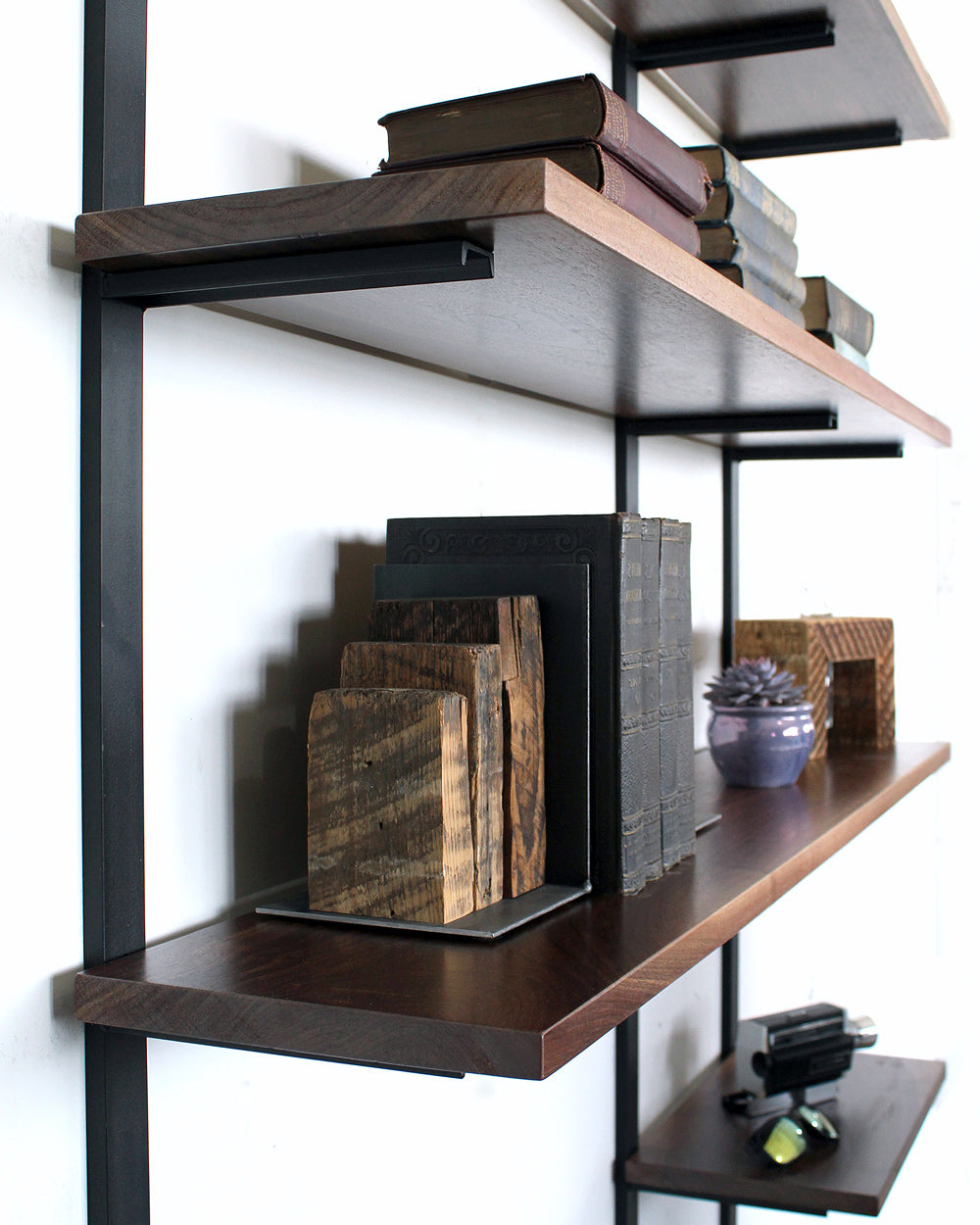heavy-duty floating shelf bracket black metal with black walnut shelves by vault furniture