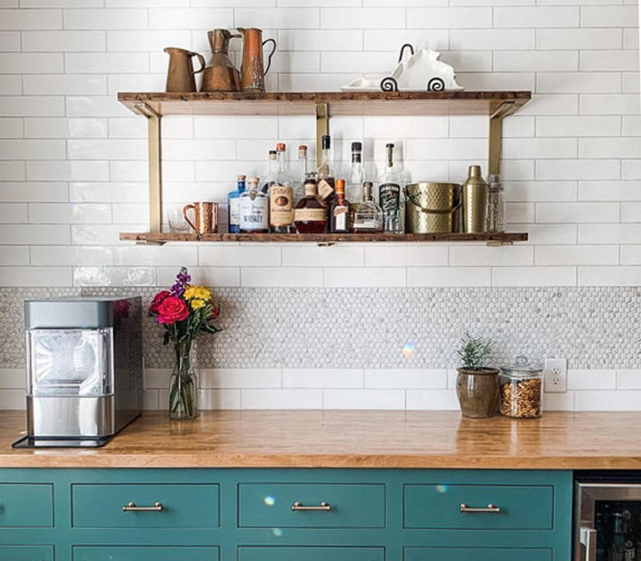 Heavy-duty floating shelves in a modern rustic kitchen for display and storage. Black walnut solid wood wall-mounted shelves and brass steel brackets.