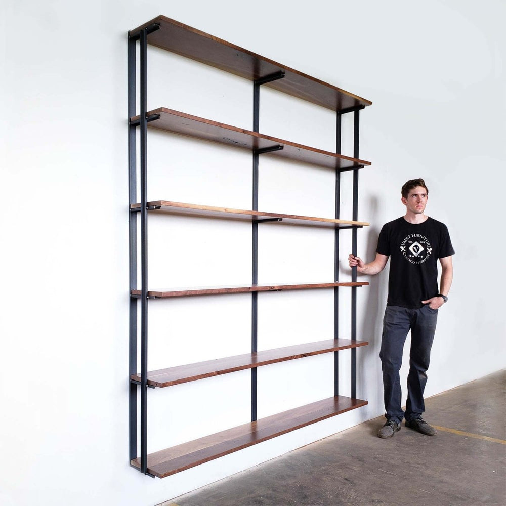 Tall wall mount floating bookshelves. Heavy duty steel bookcase brackets on white wall. 