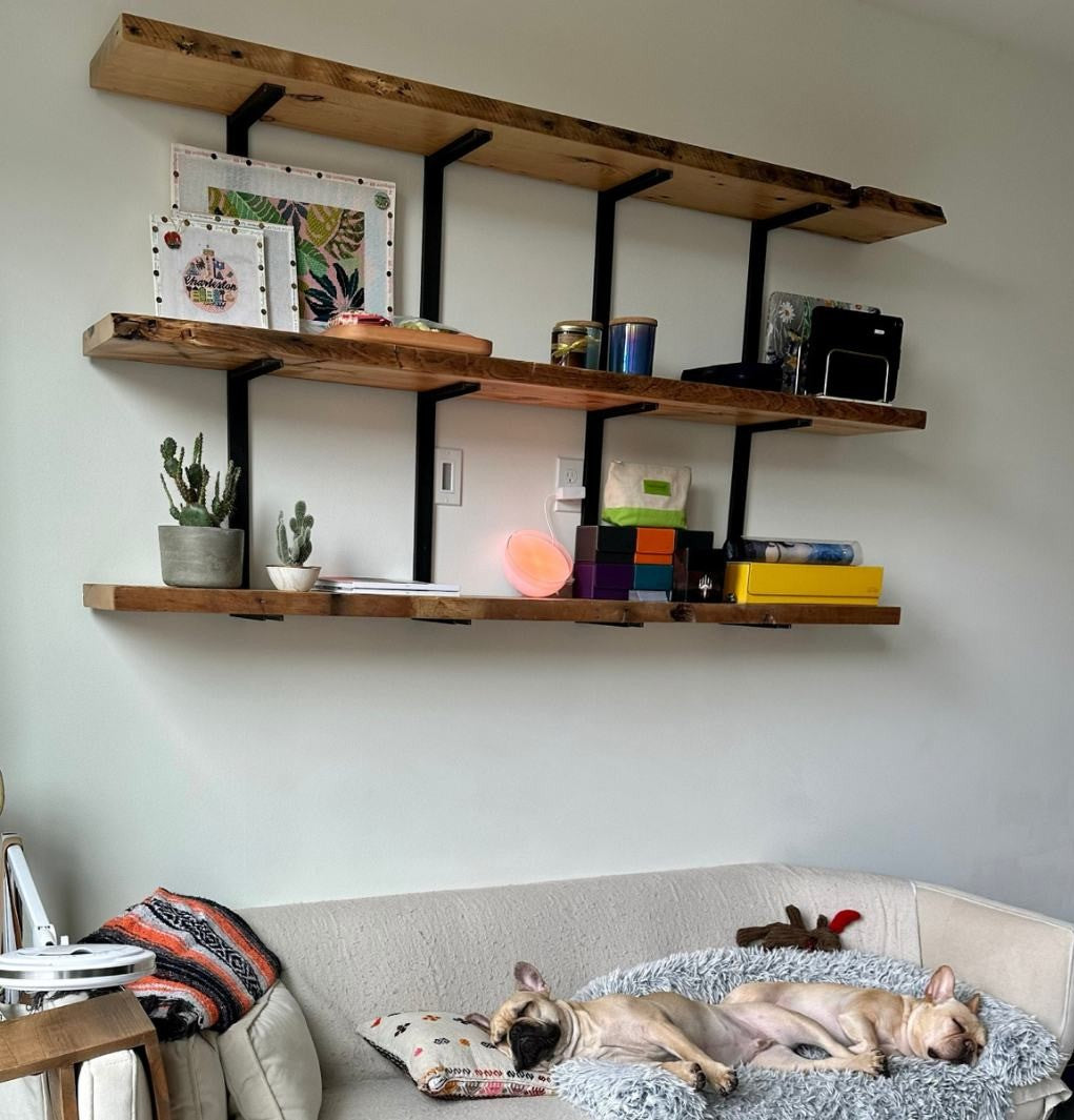 Heavy duty reclaimed pine wood shelving unit and strong steel brackets in a modern living room. wall mounted bookshelves for storage and display.