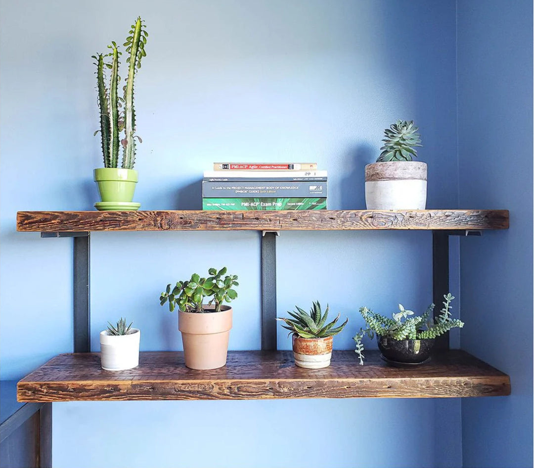 Heavy duty reclaime dpine wood shelves and black steel brackets for a minimal bookshelf design.