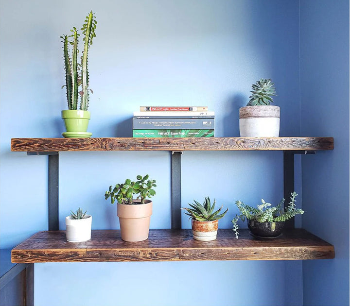 Heavy duty reclaime dpine wood shelves and black steel brackets for a minimal bookshelf design.