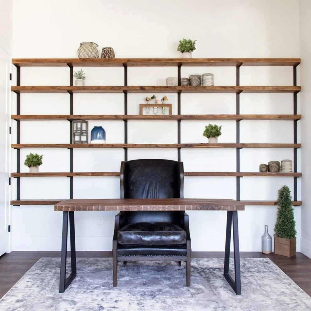 Built in shelving unit, large bookcase display in a home office. Solid black walnut wood and steel brackets.