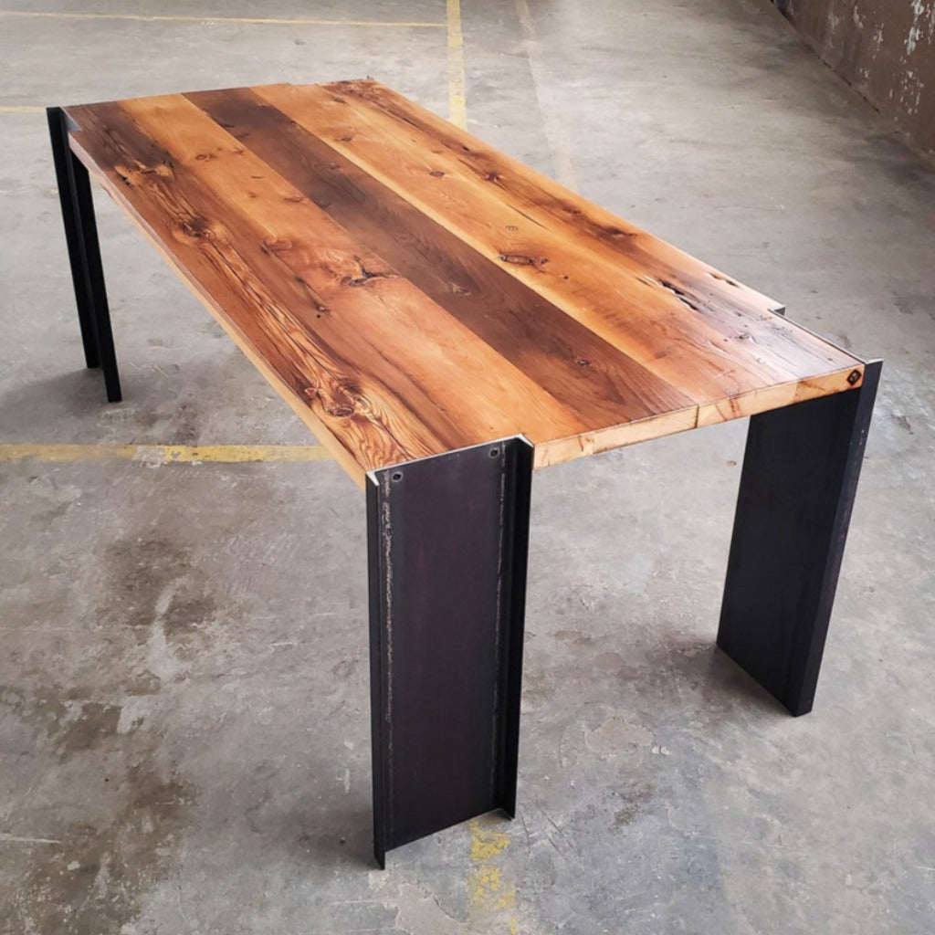 Handmade American reclaimed pine dining table with steel legs. Modern, industrial, sleek, minimalist design. Wood and metal dining room table. 